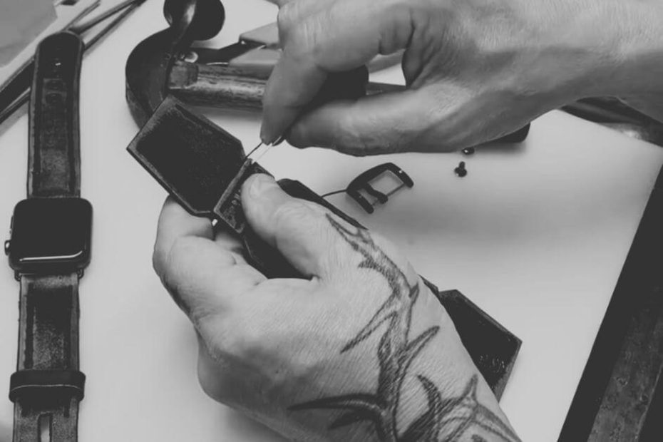 Craftsperson hand-stitching premium leather watch band showing traditional artisan techniques and quality craftsmanship