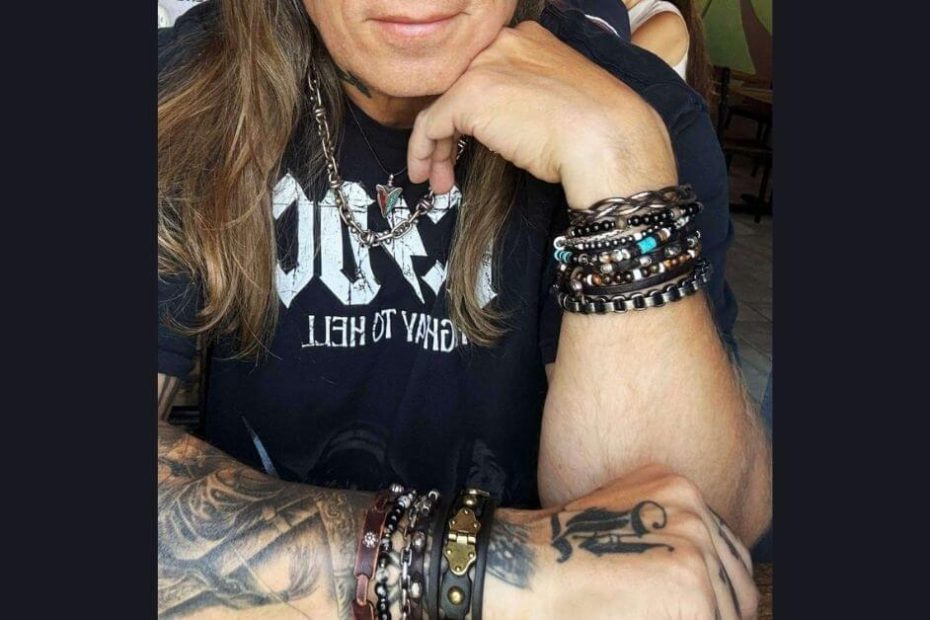 Man wearing multiple stacked leather bracelets showing layered bracelet styling